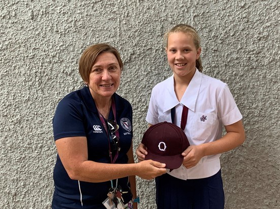 Ms Anita Woodward and Darcy Gurrieri-Hyland holding her maroon cap